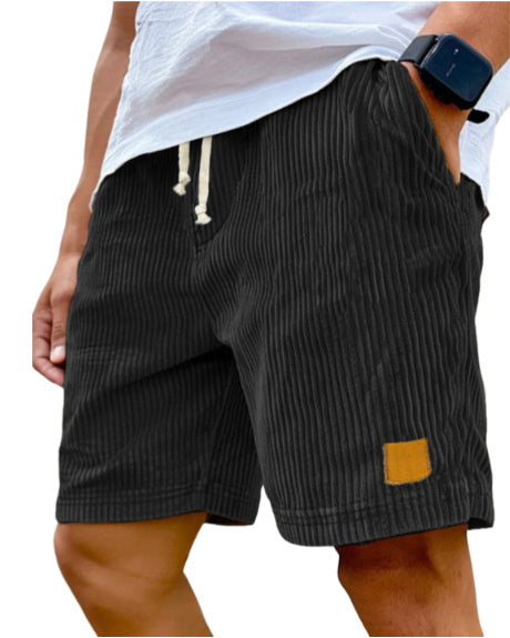 Black striped shorts worn by a person on a white background